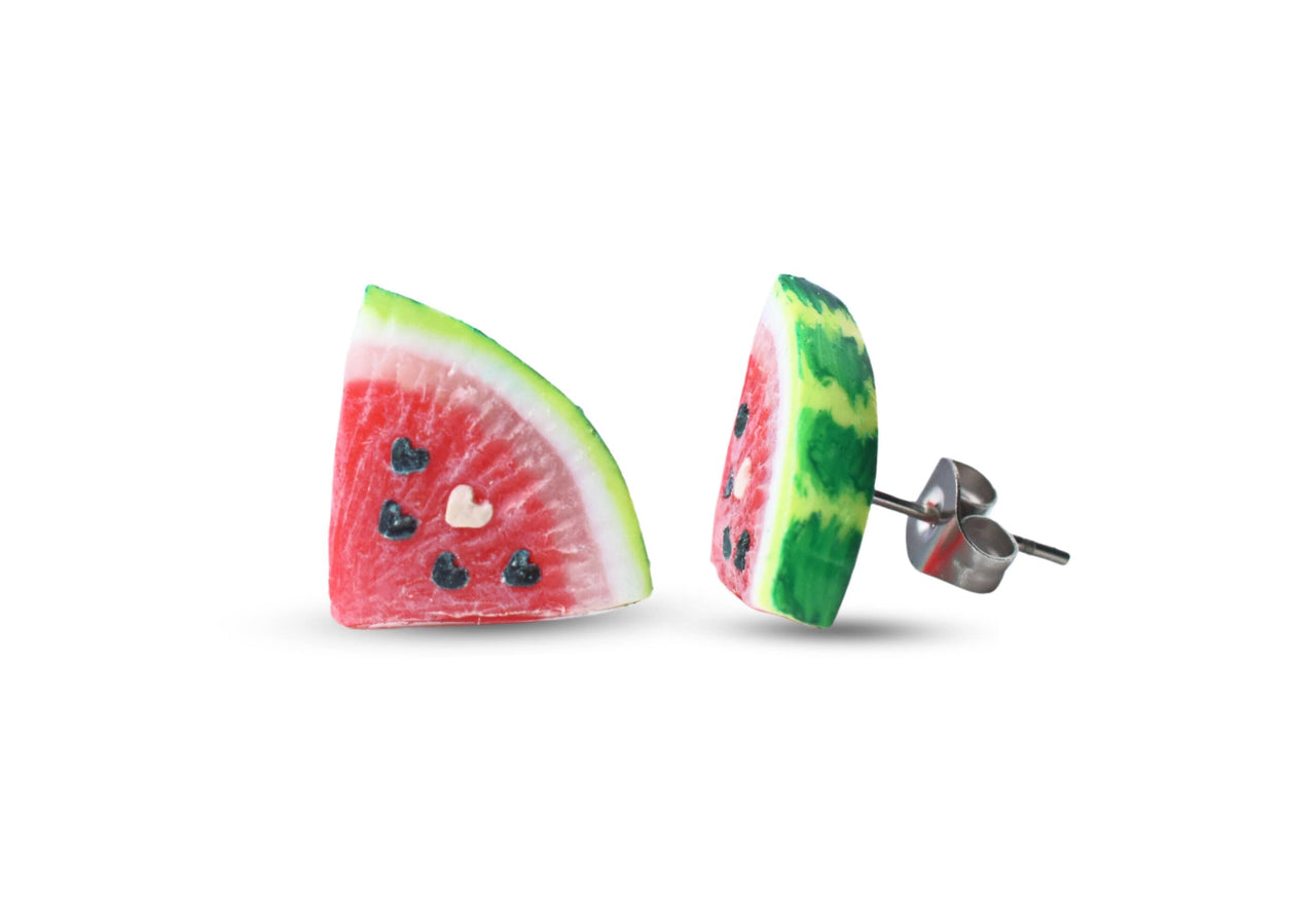 A pair of watermelon slice stud earrings with heart seeds, made of polymer clay, displayed against a white background.