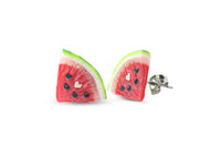 Thumbnail for A pair of watermelon slice stud earrings with heart seeds, made of polymer clay, displayed against a white background.