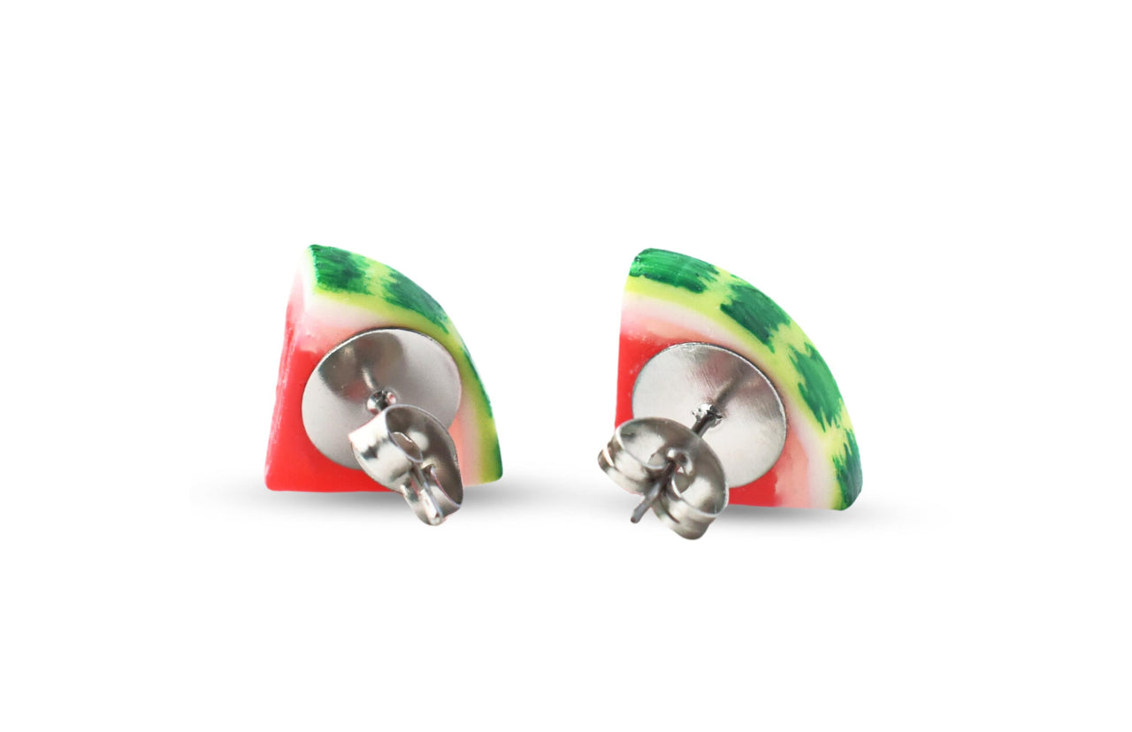 The back of a pair of watermelon slice stud earrings with heart seeds, made of polymer clay, displayed against a white background.