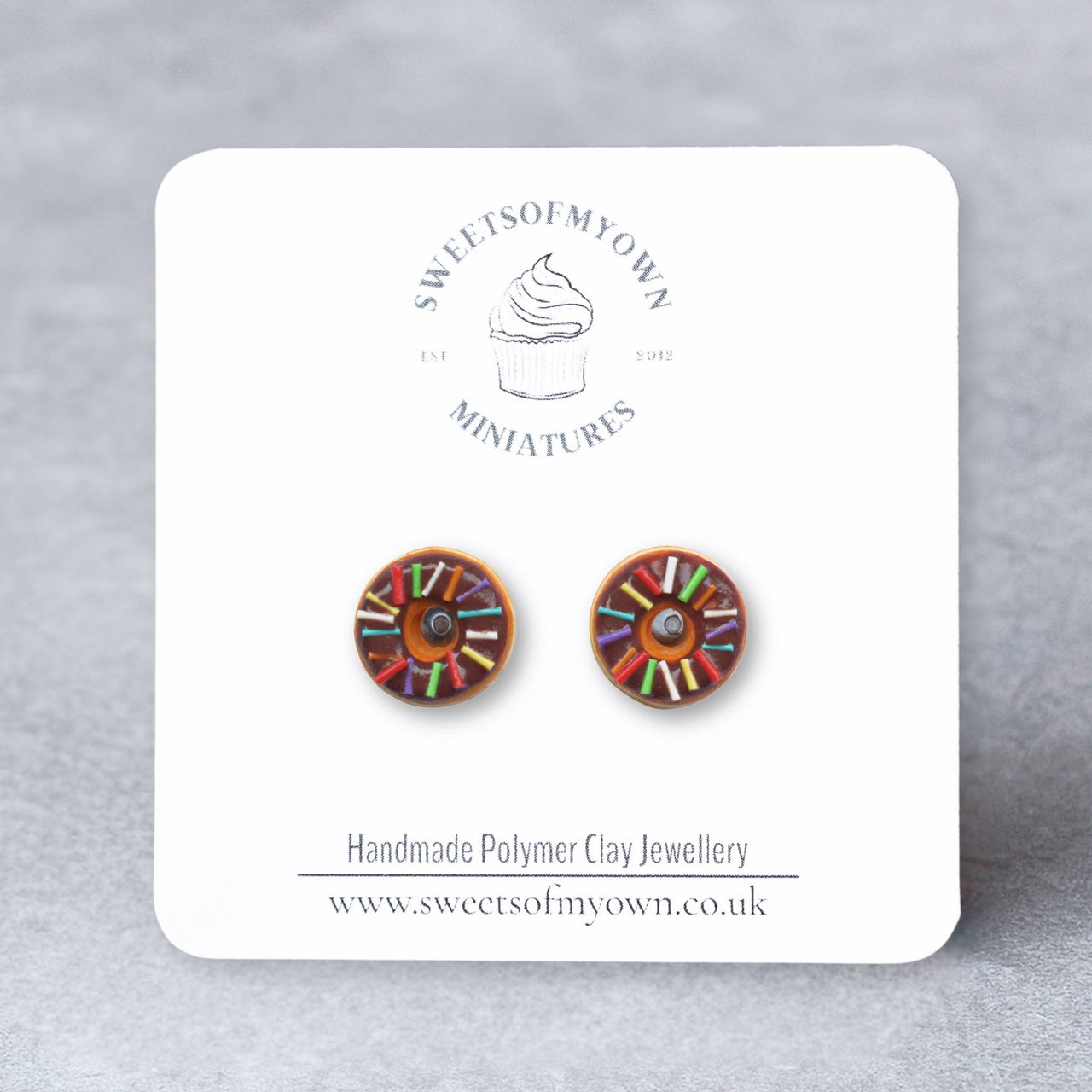 Chocolate Doughnuts with Rainbow Spinkles as Stud Earrings on a sweetsofmyown branded backing card.