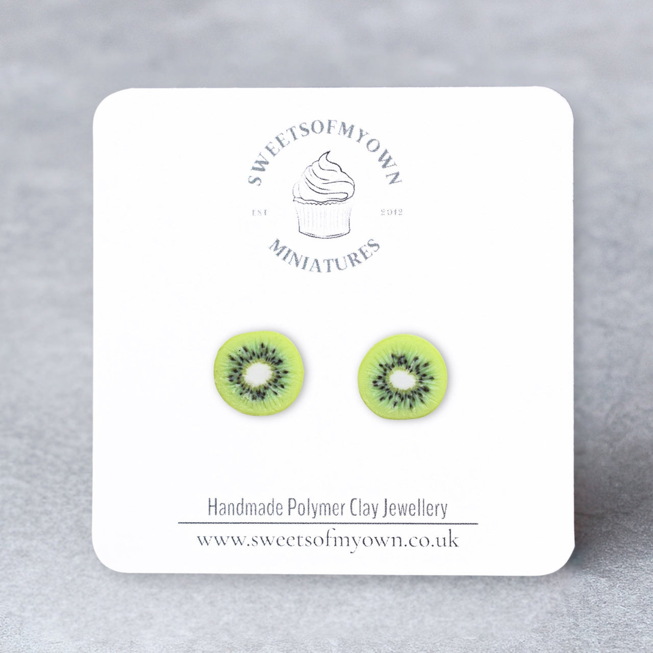 Realistic Polymer Clay Kiwi Slices Stud Earrings on a sweetsofmyown backing card.