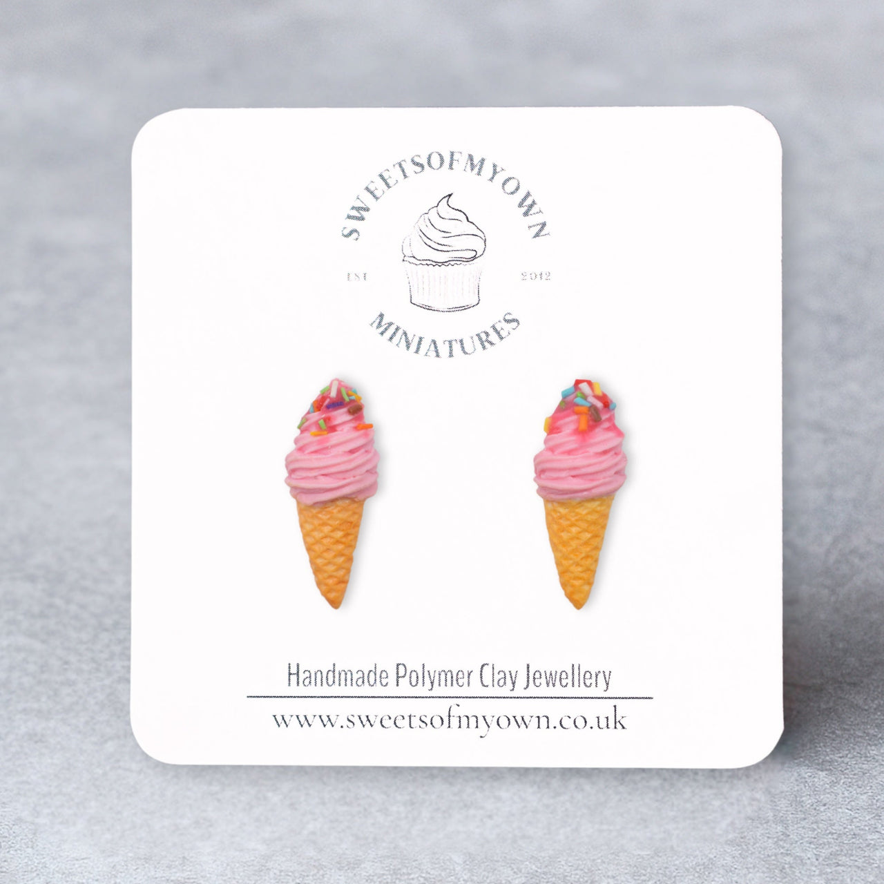 Pink swirl ice cream cone stud earrings topped with sprinkles on a sweetsofmyown backing card.