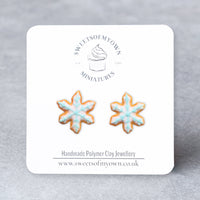 Thumbnail for Snowflake-shaped earrings on a branded card with a gray background