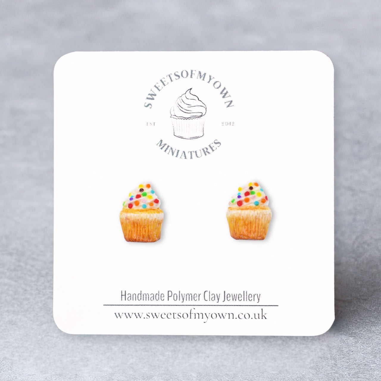 Vanilla Cupcakes with White Frosting and rainbow confetti sprinkles as stud earrings on a sweetsofmyown backing card. 